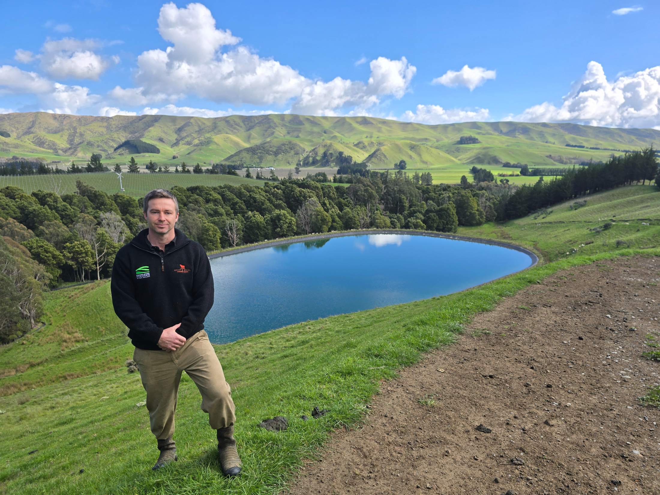 Richard Dawkins beside dam on his farm